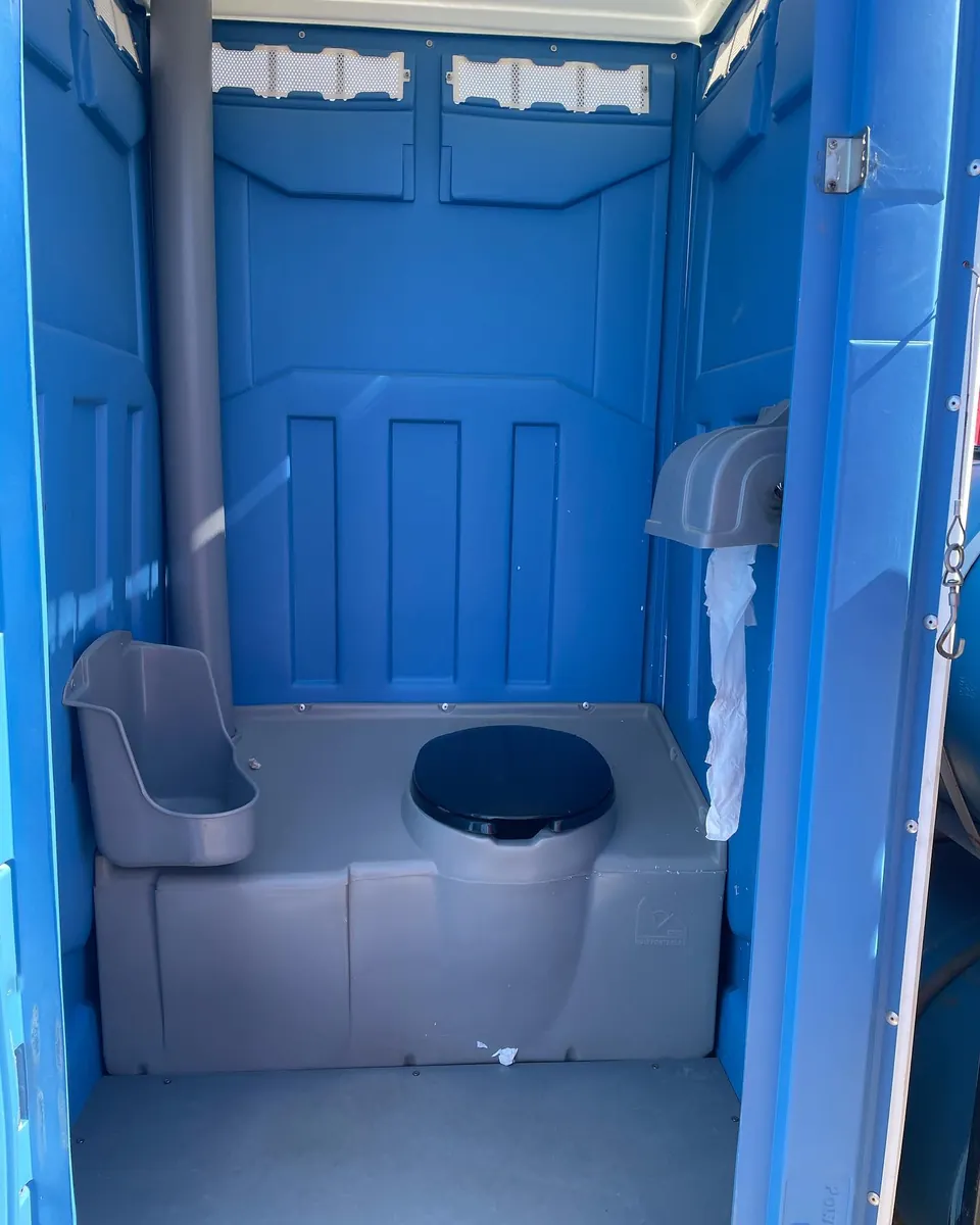 Blue portable toilet showing the seat and urinal